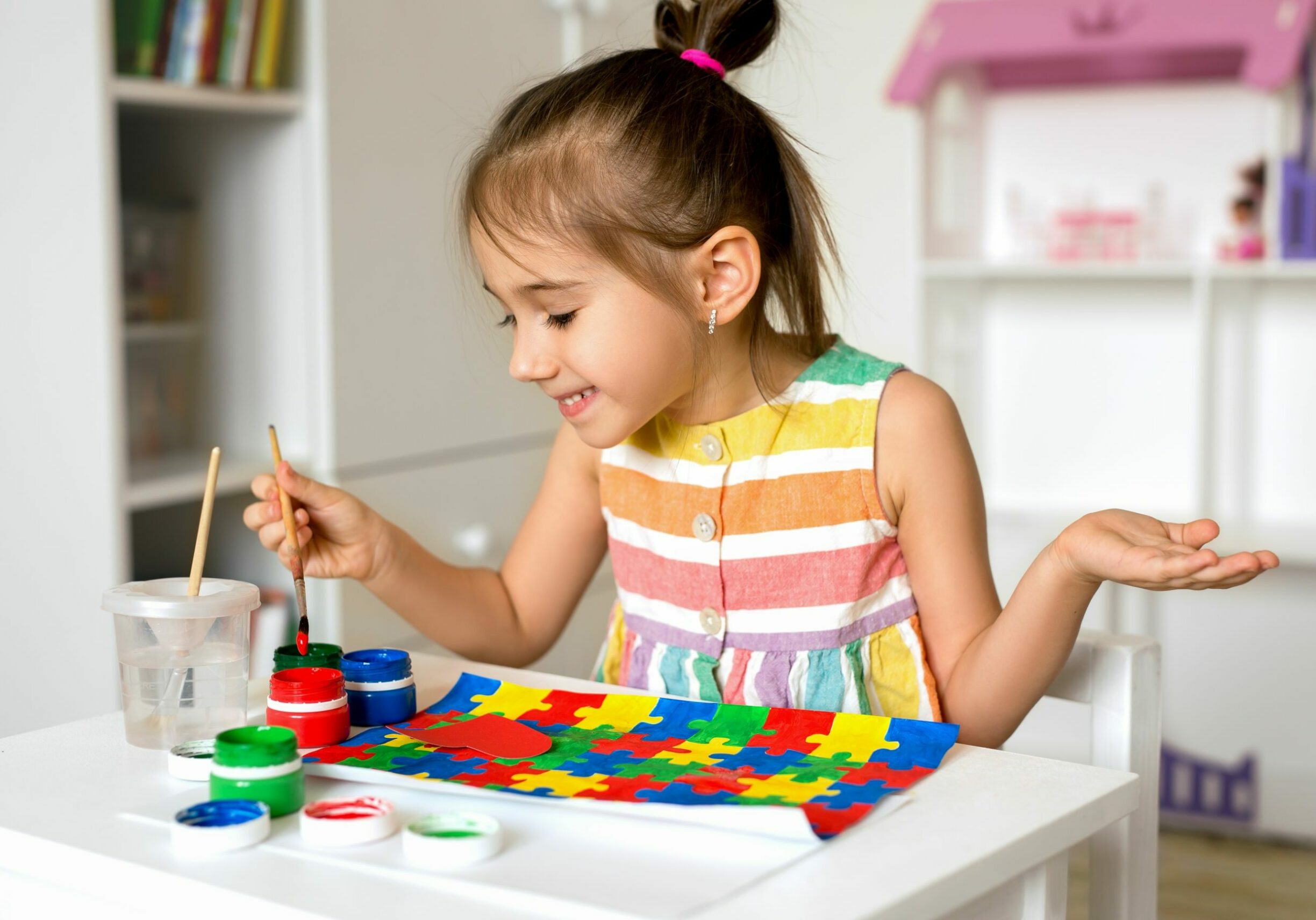 child-draws-bright-colorful-gouache-puzzles-autism-day